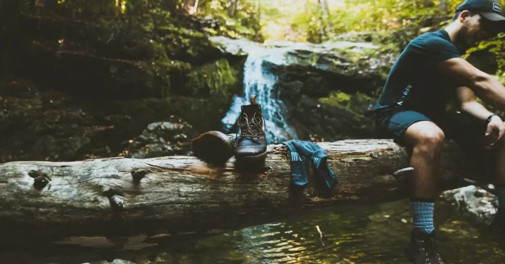 25 Gift Ideas for Veterans 2024 (#5 Will Suprise You) 4 man sitting on a log over a river