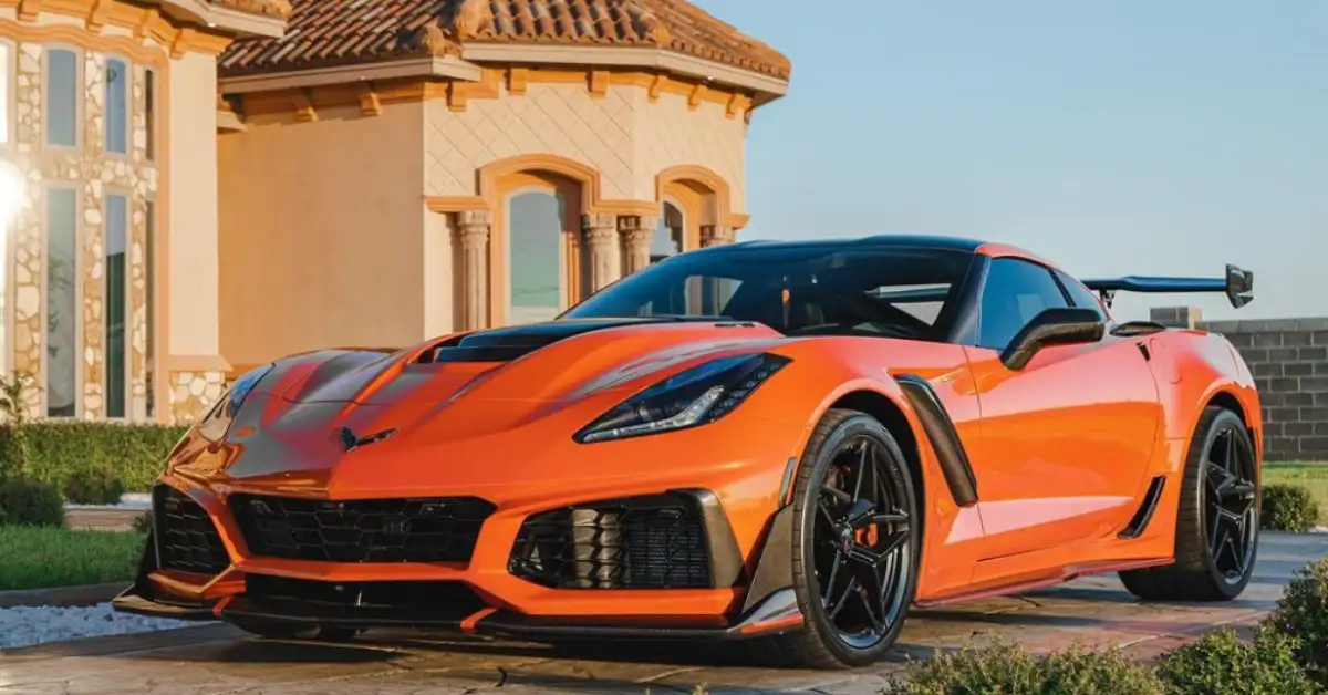 orange corvette zr1 in front of a villa