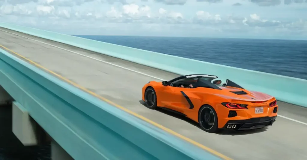 15 Unique Gifts For Corvette Lovers 2024: Perfect Presents 2 orange corvette cabrio on a bridge